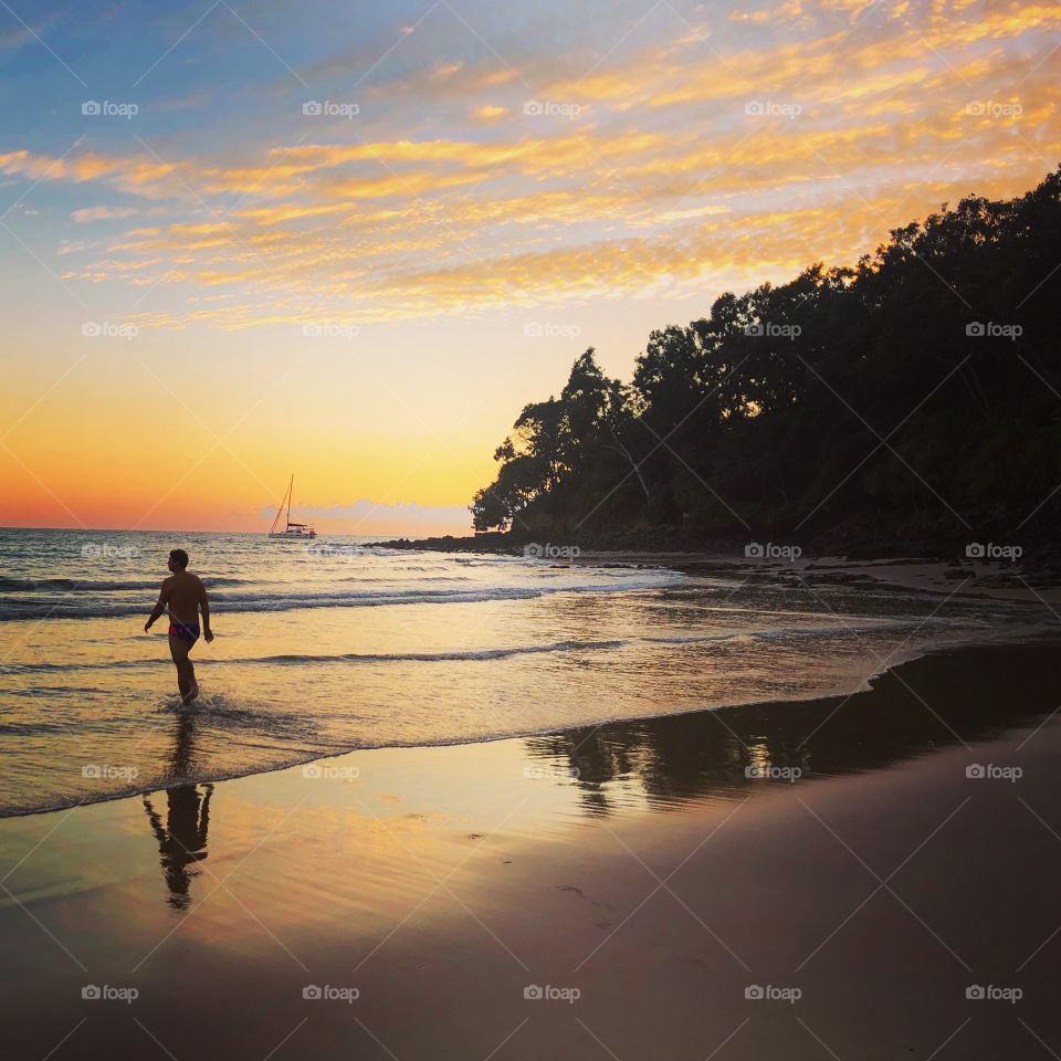The swimmer at dawn in the ocean 