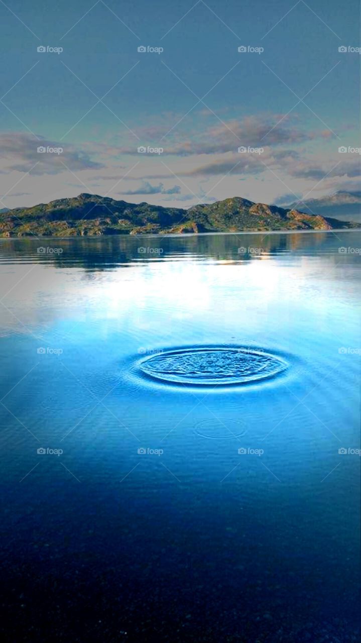 A stone disturbs the calm of Skilak Lake, Alaska