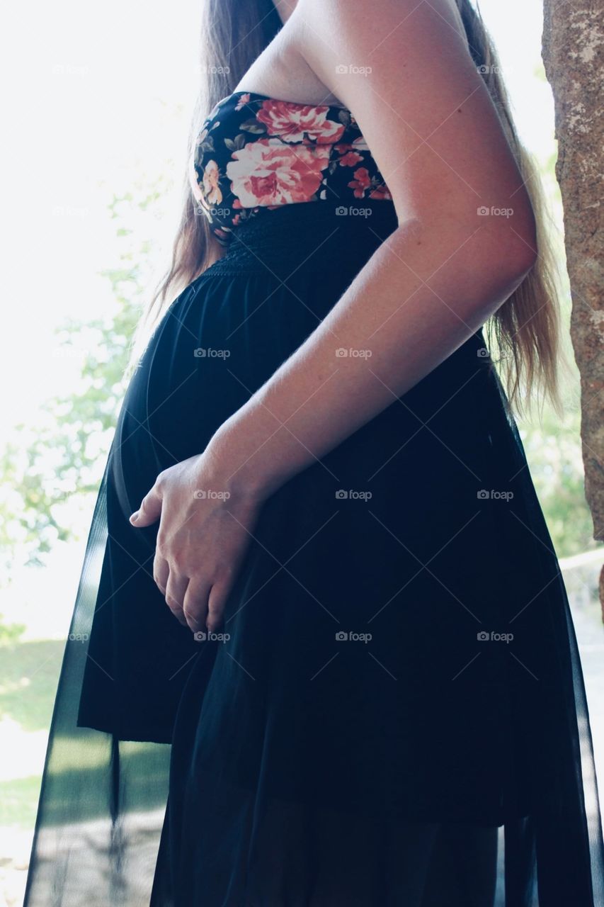 Side view of baby bump in beautiful sheer dress 