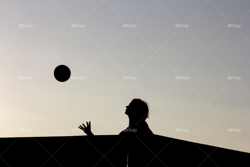 Silhouette of a woman and a ball outdoor