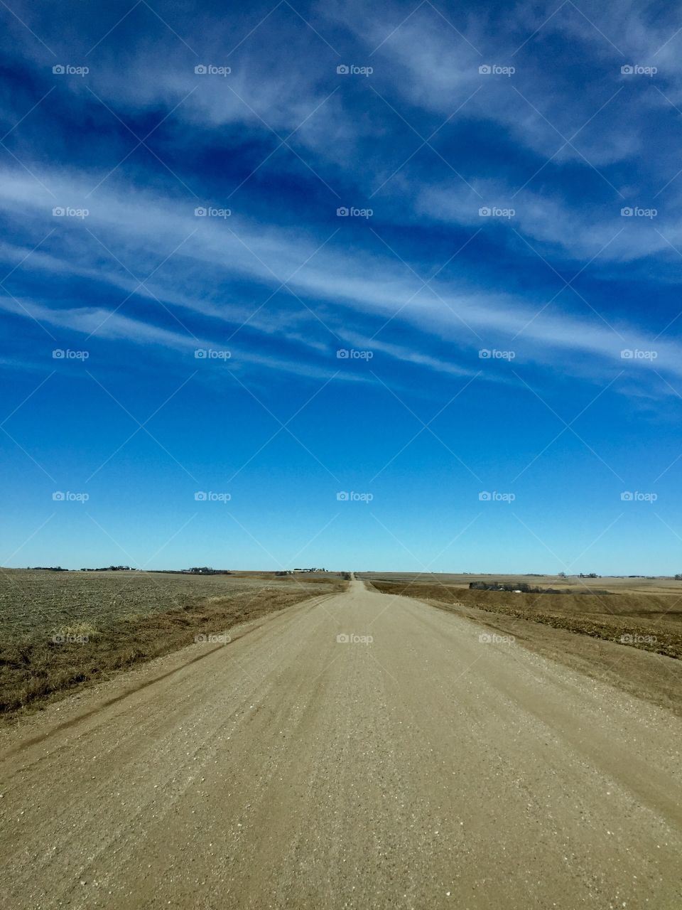 Empty road against blue sky  