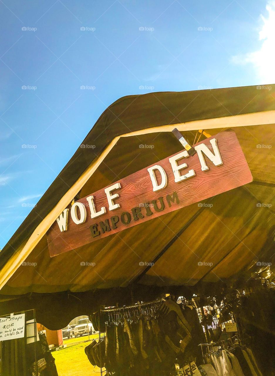 It is Wolf Den Emporium at the Renaissance Faire in Visalia, California, on a late Sunday afternoon. This vendor is in the business of crafting and marketing leather goods.