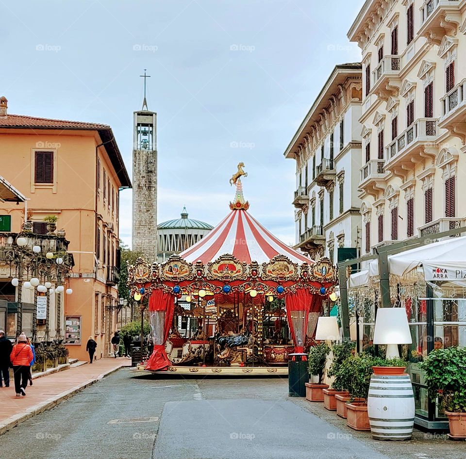 Colorful circus house on the town squer. Dominance of geometric shapes: triangle,  rectangle, and circles