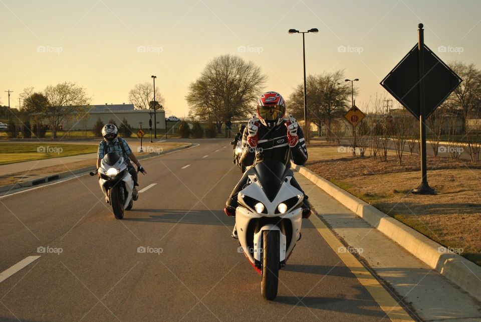 Riding motorcycles at dusk.