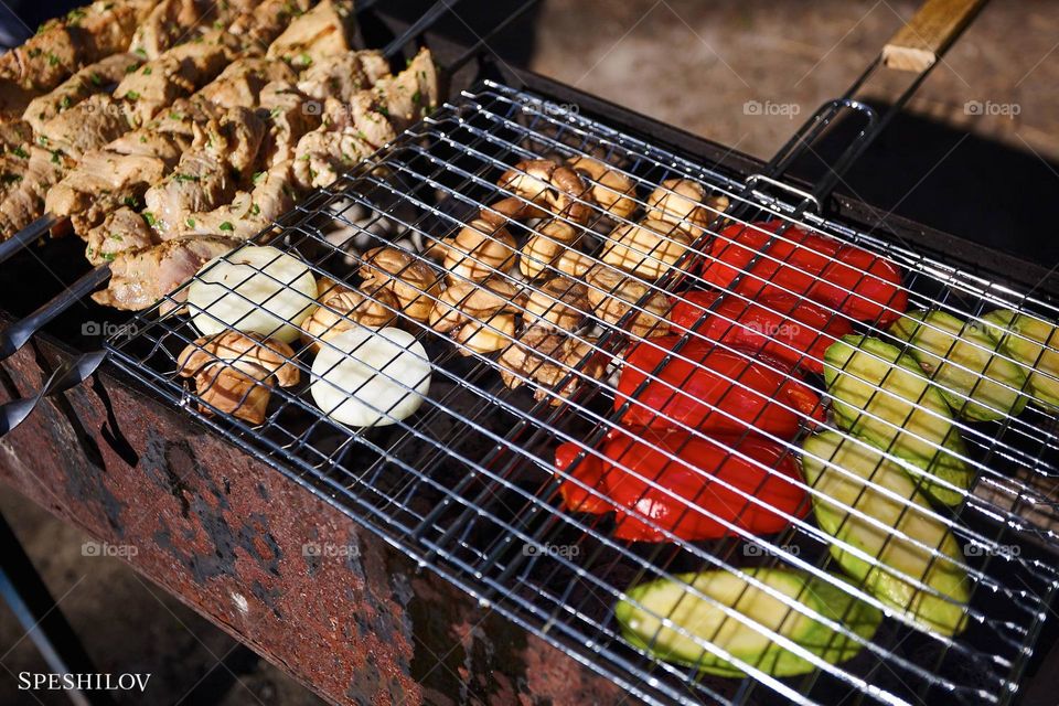 high-contrast photo of vegetables being grilled in the backyard of their home