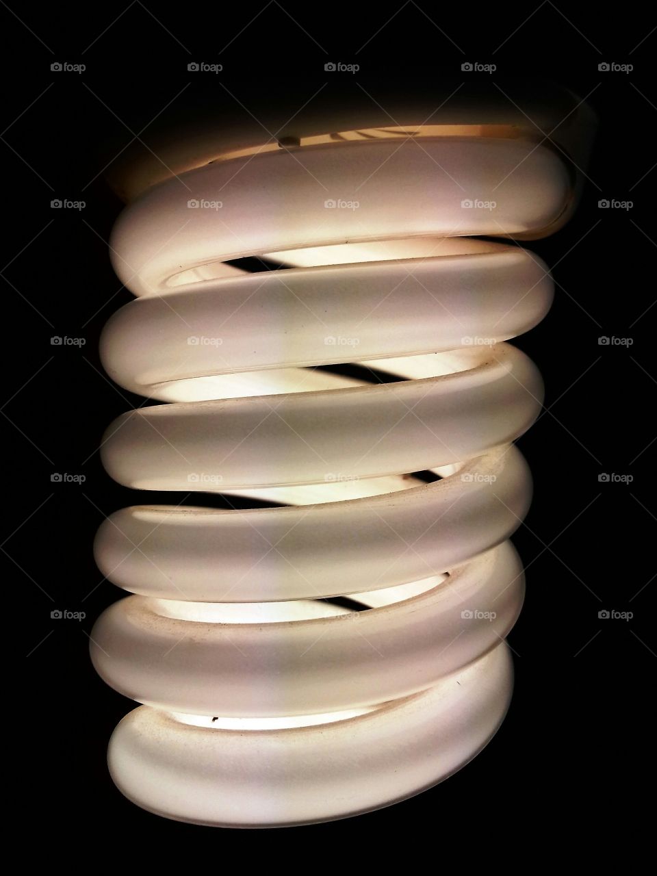 Spiral energy saving light lamp bulb on dark background