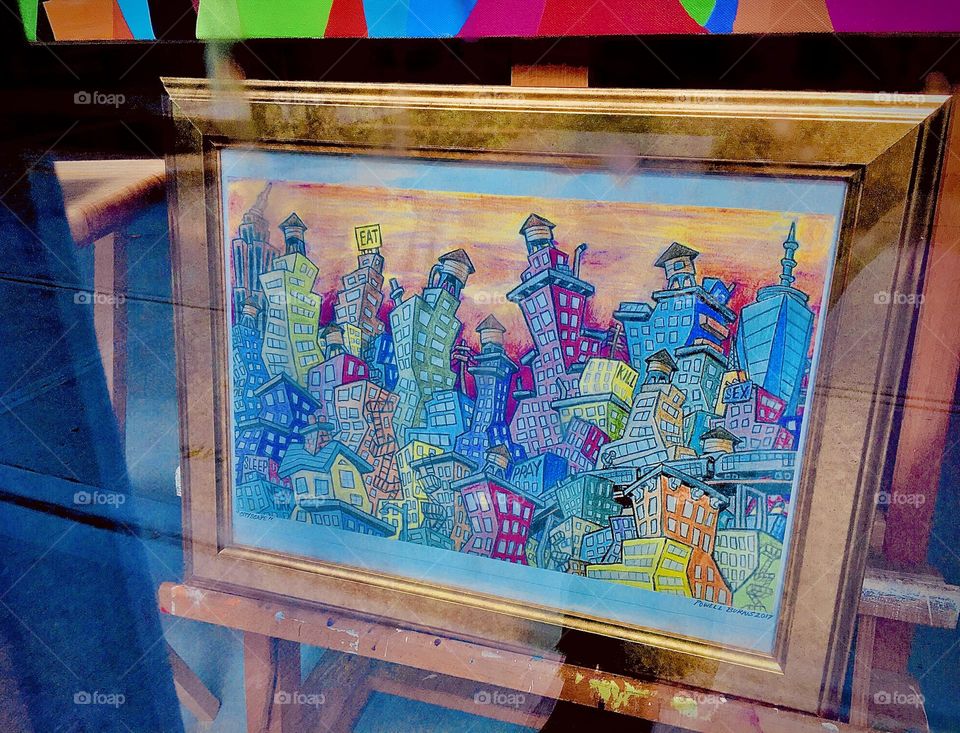 The pastel colors of this gold framed painting on display at a local store on “Fulton St” in “Clinton Hill”, Brooklyn sets a soulful mood for a bright sunny afternoon. 2021. Hypnotic Productions