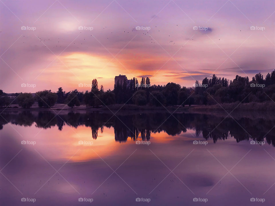 Reflection of a beautiful purple sunset over the lake 
