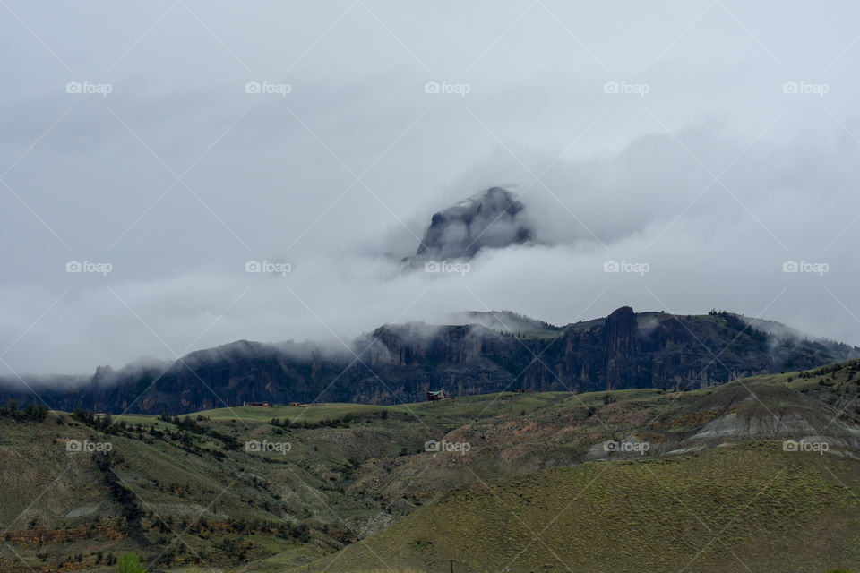 clouds surrounding a mountain scenery