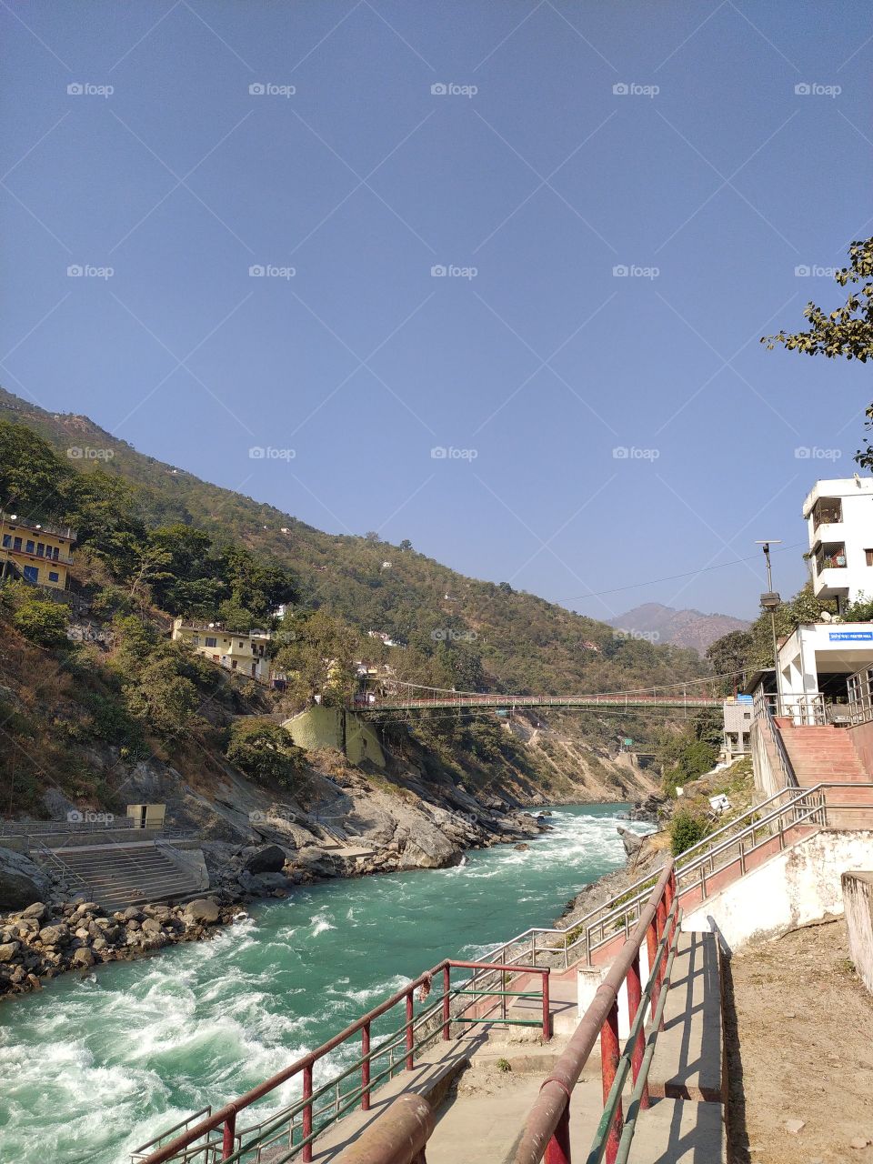 A beautiful view of the sacred river Bhagirathi (Ganga), hanging bridge over it and the mountains