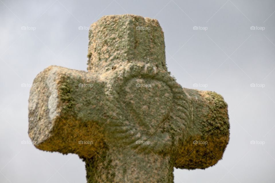 stone cross on the background of blue sky