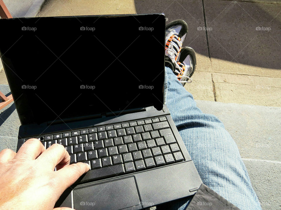 Closeup View Of Person's Hand Typing On A Laptop Computer Relaxing In Casual Clothes