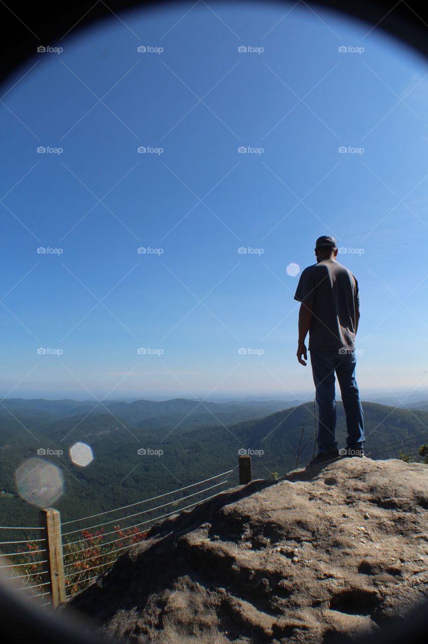 Man on top of mountain after long hike
