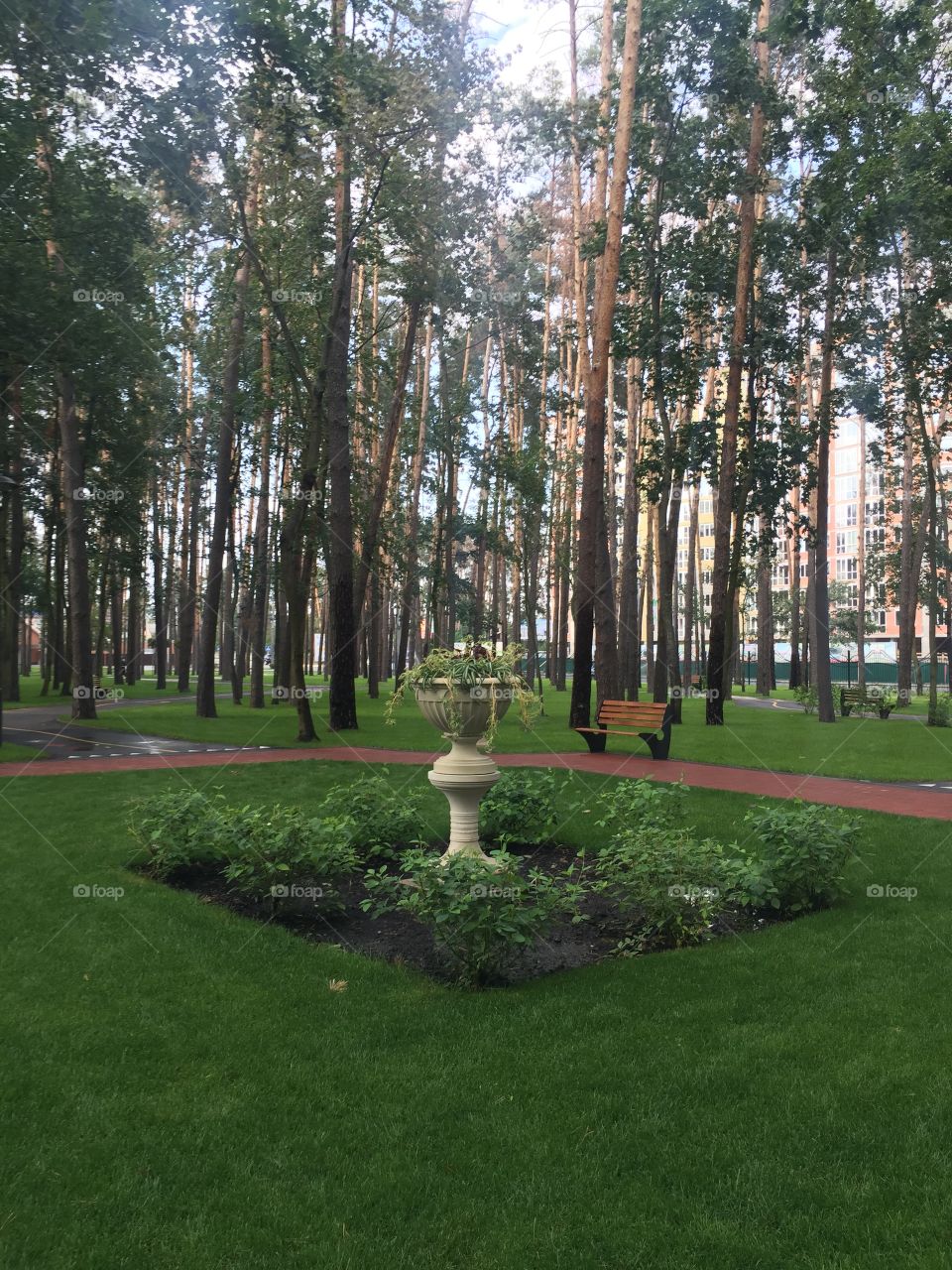 Flower bed with flowers in a pot in ancient style in a park