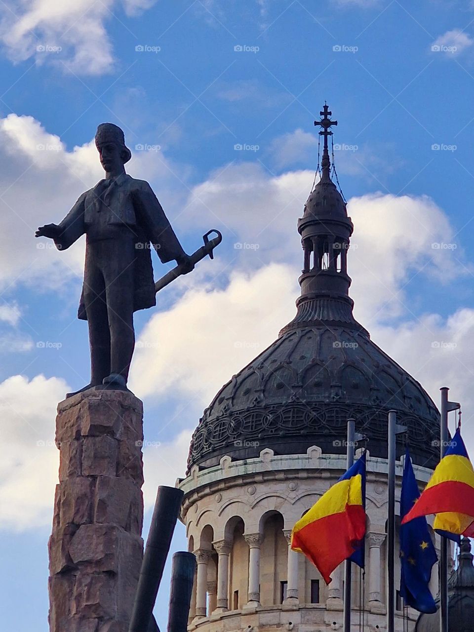 the statue of Avram Iancu and the tower of the Metropolitan Cathedral in Cluj-Napoca