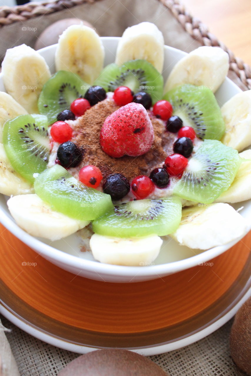 Breakfast with berries and banana and kiwi