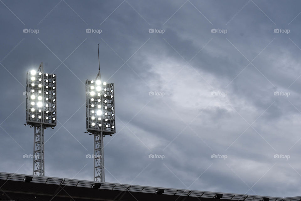 Baseball stadium lights turned on at dusk