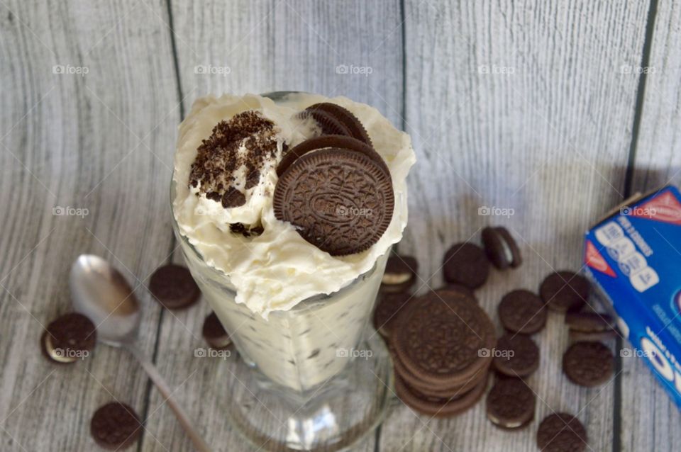 Oreo cookie milkshake with a wooden rustic white background