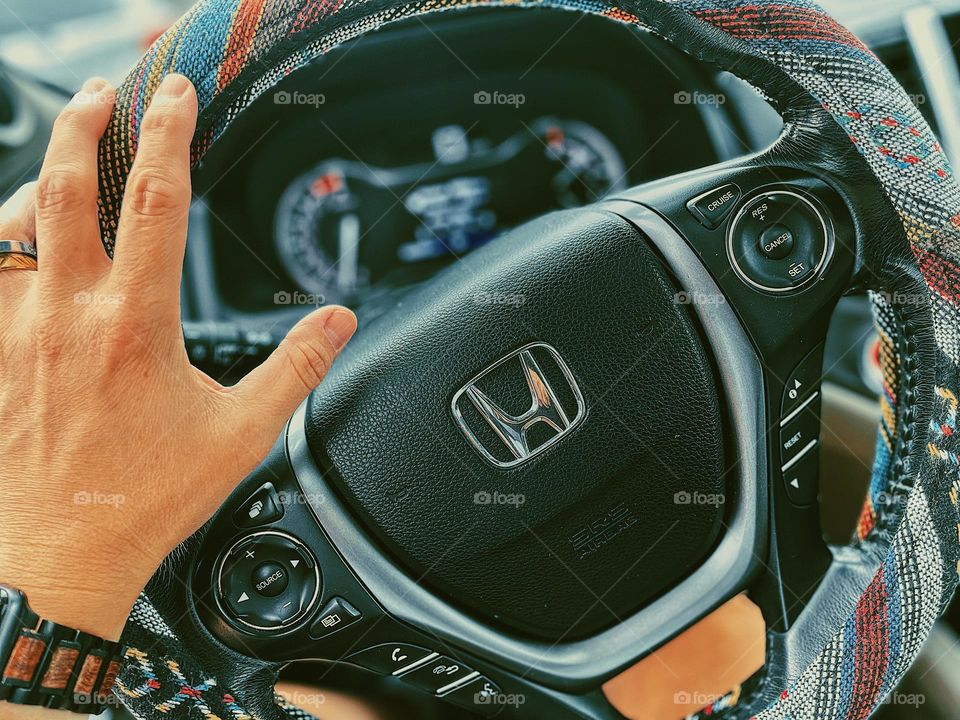 Woman’s hands on steering wheel, driving a Honda Pilot, steering a car, driving to work 