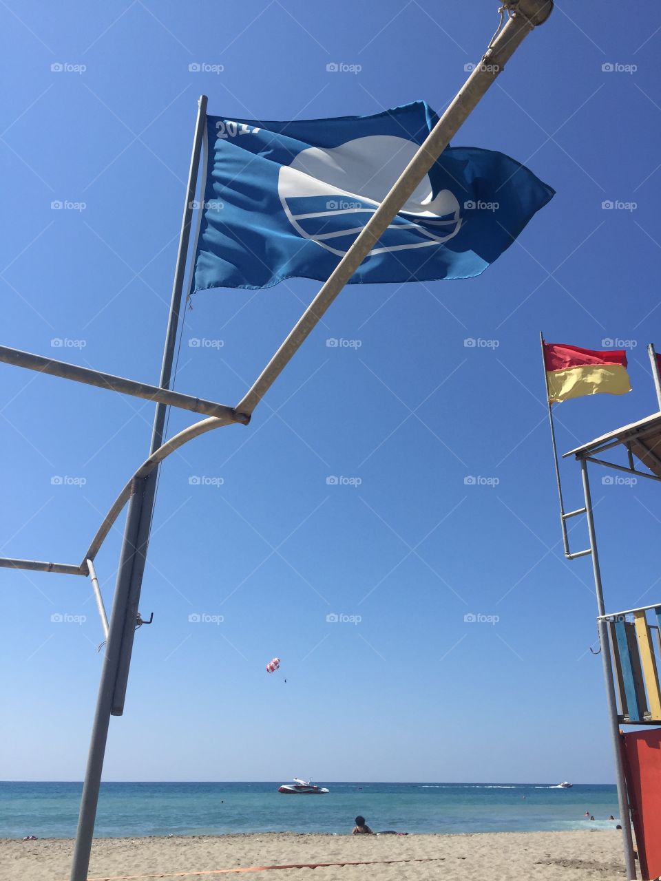 Blue flag on the beach in turkey is a symbol of pure water