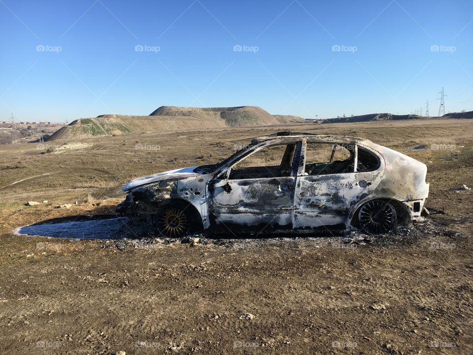 Car burned in the countryside, side view