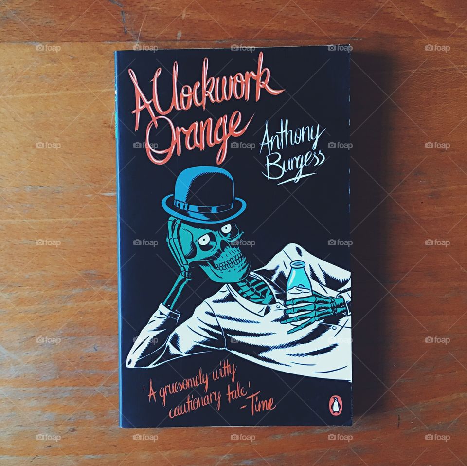 A Clockwork Orange, a book by Anthony Burgess, lying on a wooden desk.