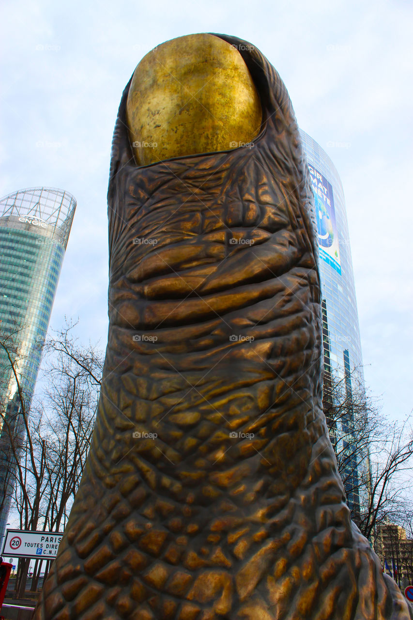 statue in the shape of an inch at Le Defence,Paris