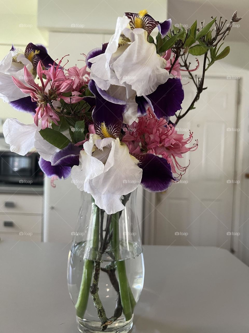 Irises and Pink Azaleas In a Clear Vase