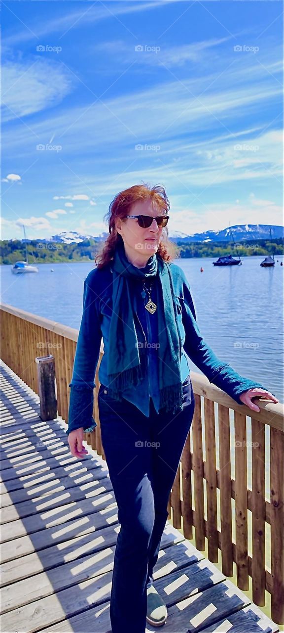 The young lady in the photograph is in „Bayerischzell“, a small town near the Alps in „Bavaria“, Germany known for at least five beautiful lakes in its surroundings that are always worth a visit. 2024. Hypnotic Productions