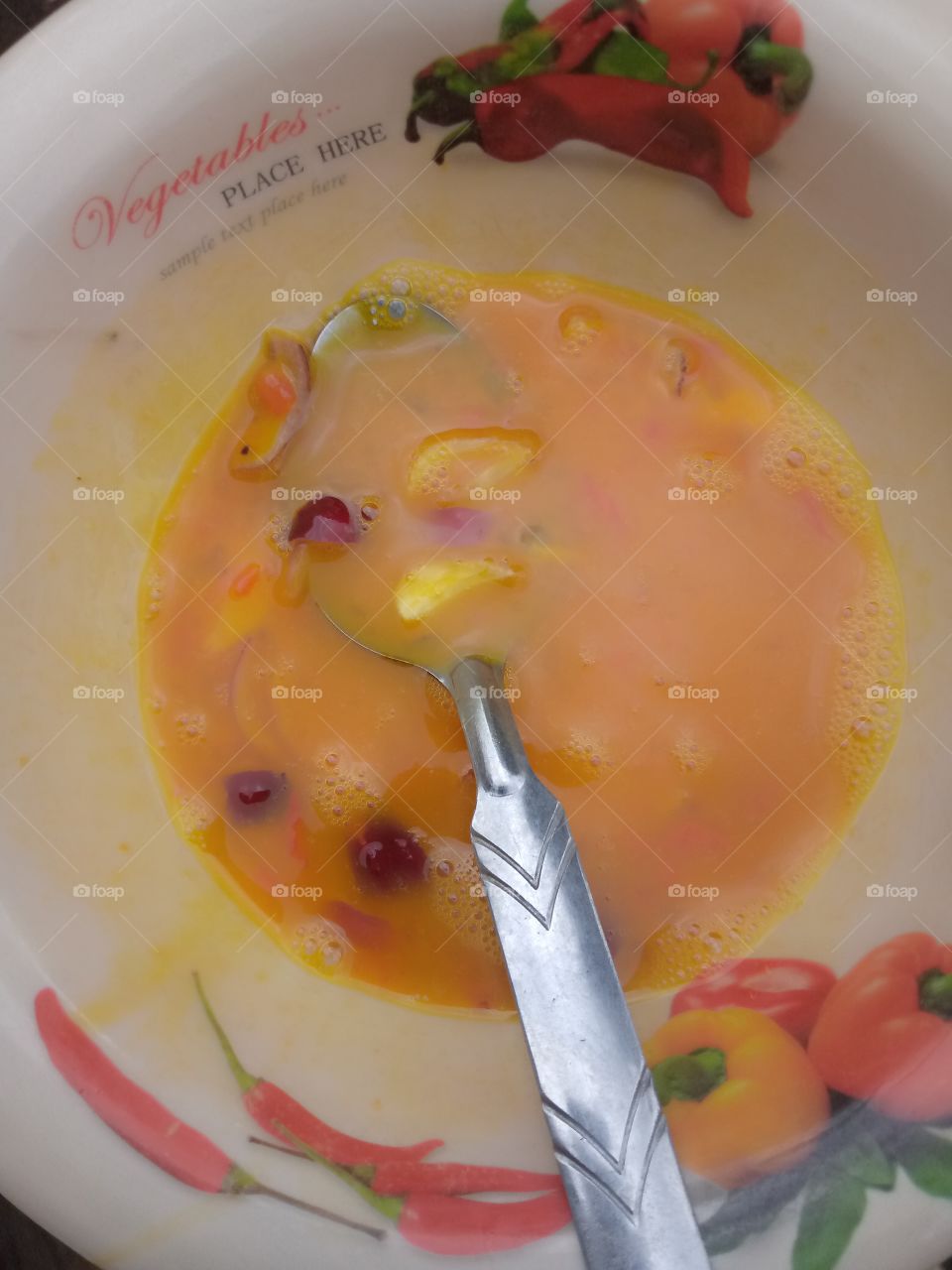 mousling eggs with the ingredients, for proper mixing before frying.