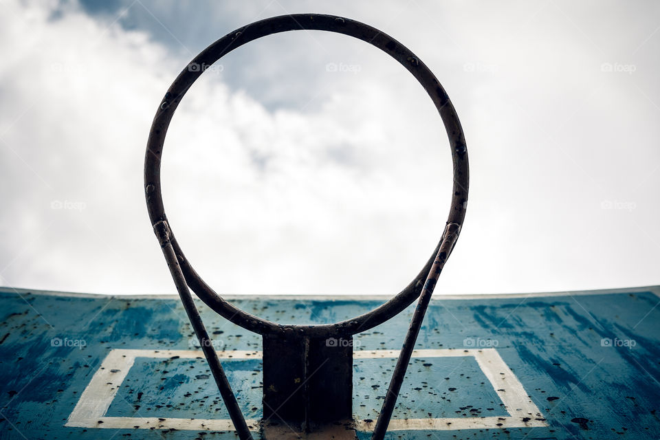 basketball hoop bottom view against cloudy sky