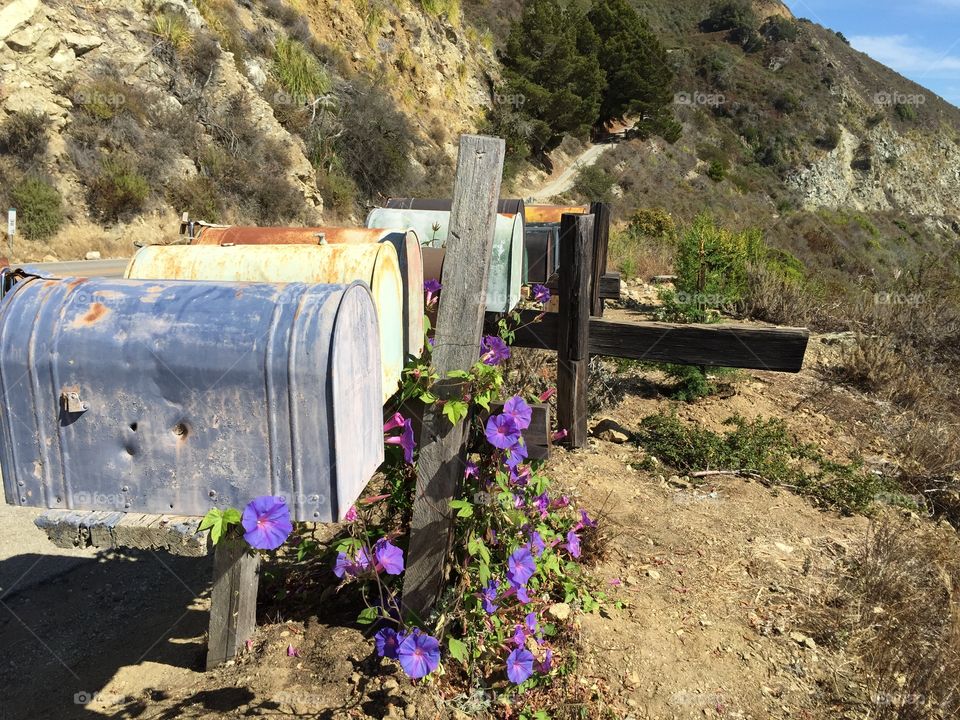 Mail box on the road beside the cliff