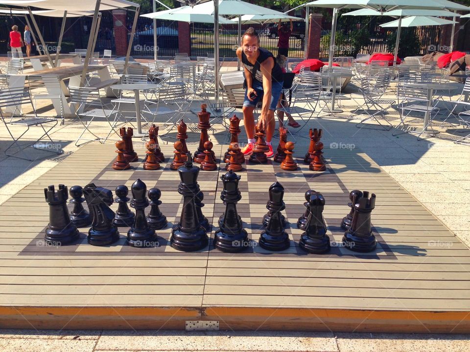 Big chess . A man play with big chess