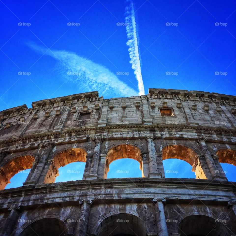 Looking up at the Roman Colosseum in mid-day 