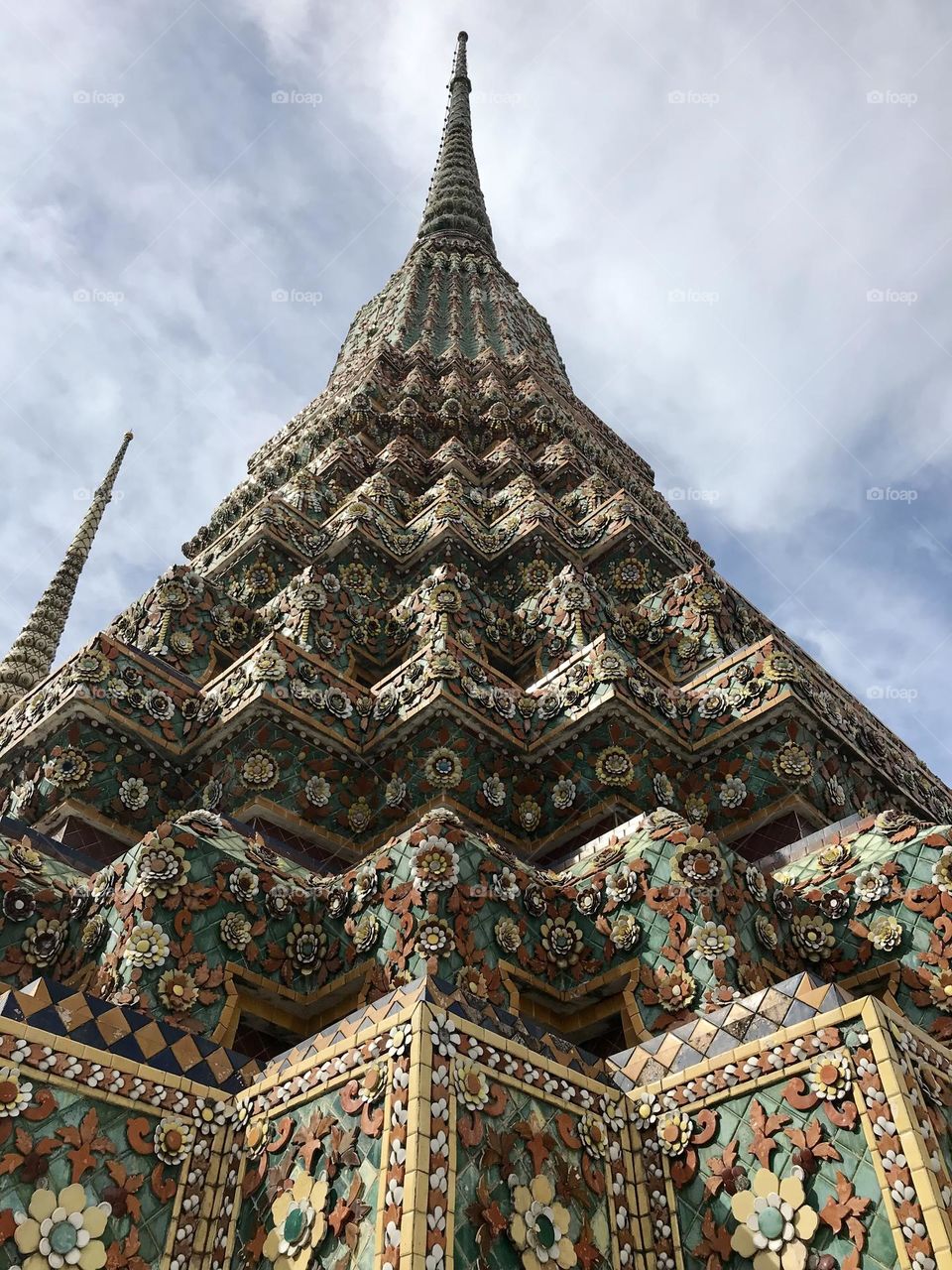 Engraved and decorated Thai temple in Bangkok, Thailand, pyramidal structure, geometrical architecture 