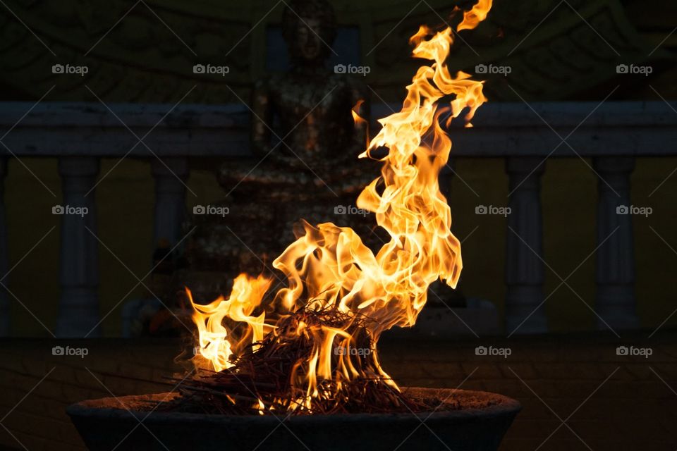 Bonfire in front of Buddha statue