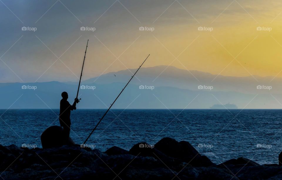 Fishermen at sunset in the beach