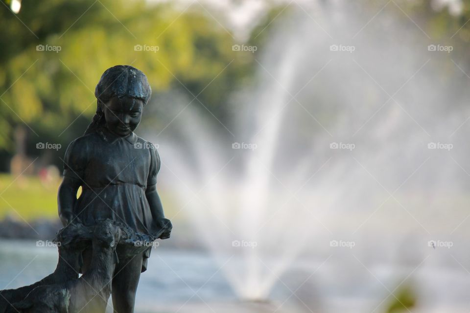 Girl Statue in front of Water Fountain 