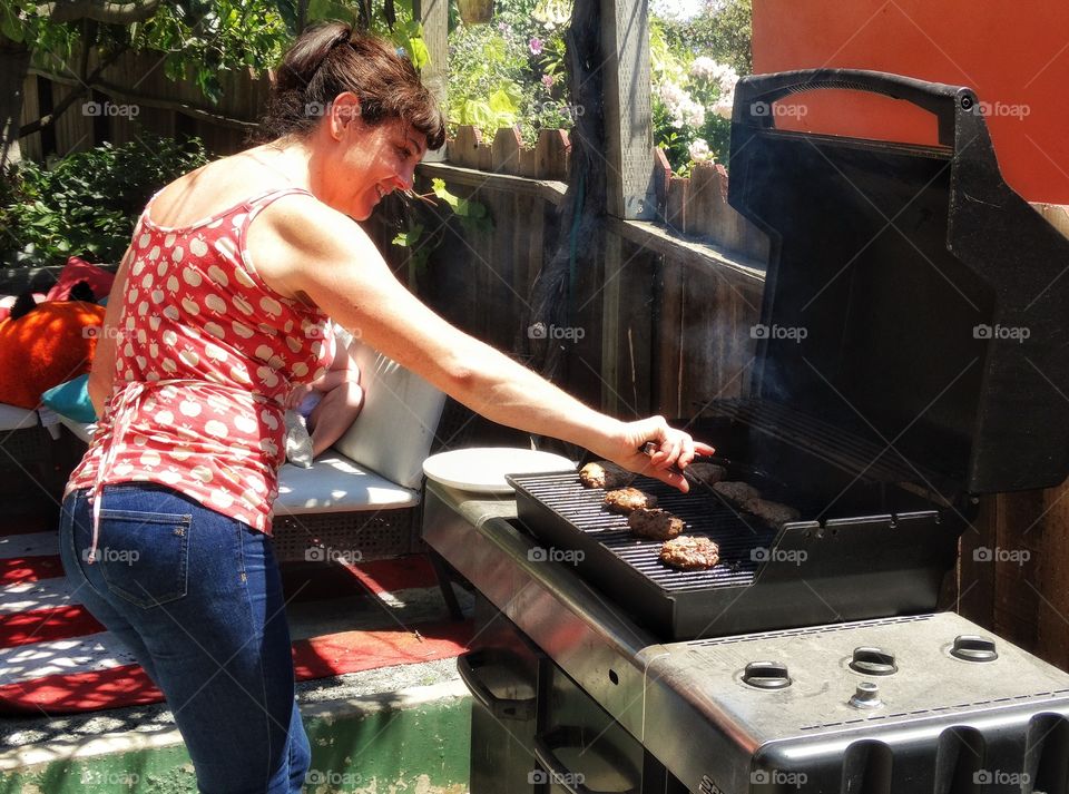 Pretty Woman Grilling Hamburgers Outside