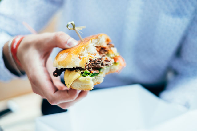 Business man eating burger 