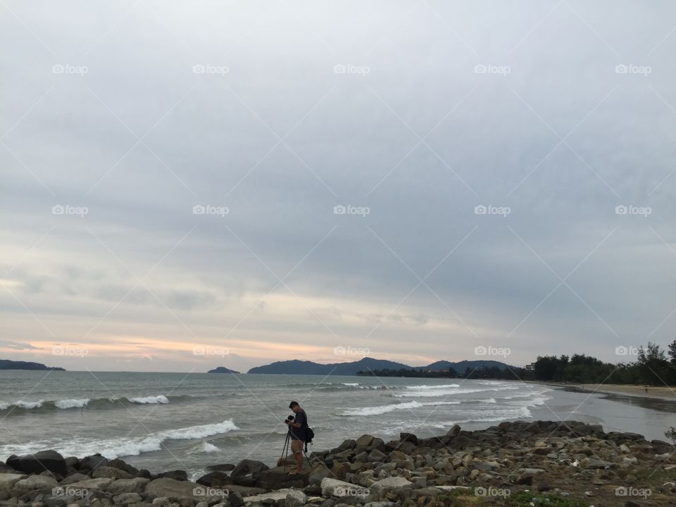 scenic view. people taking photograph of the waves 