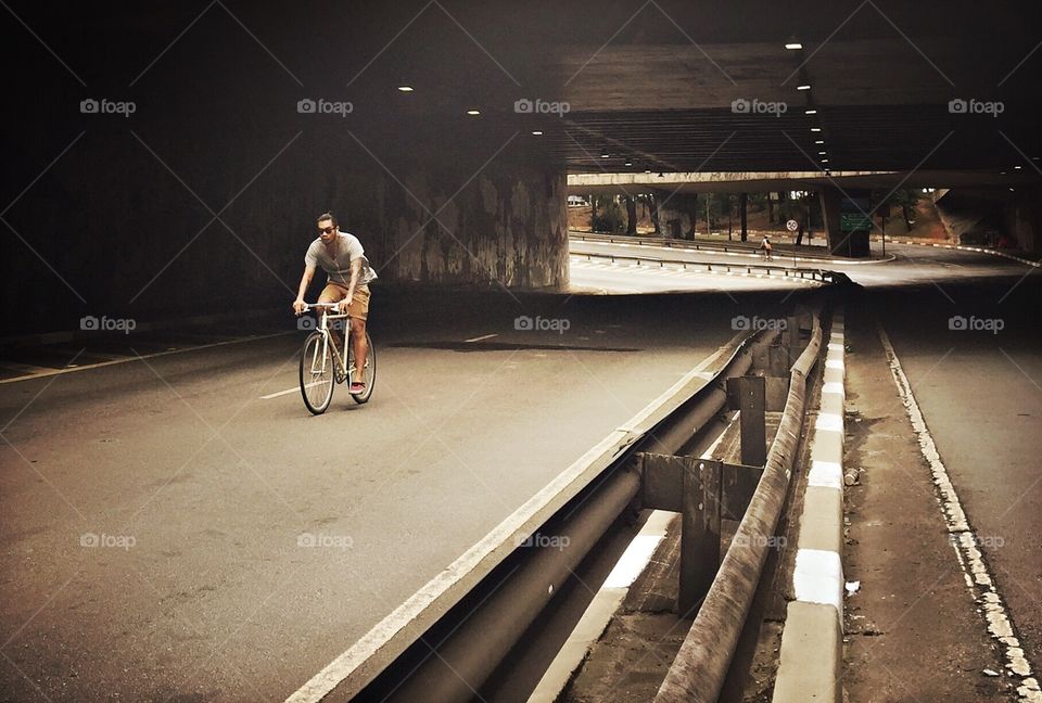 Cyclist pedal in illuminated tunnel of the city of São Paulo 