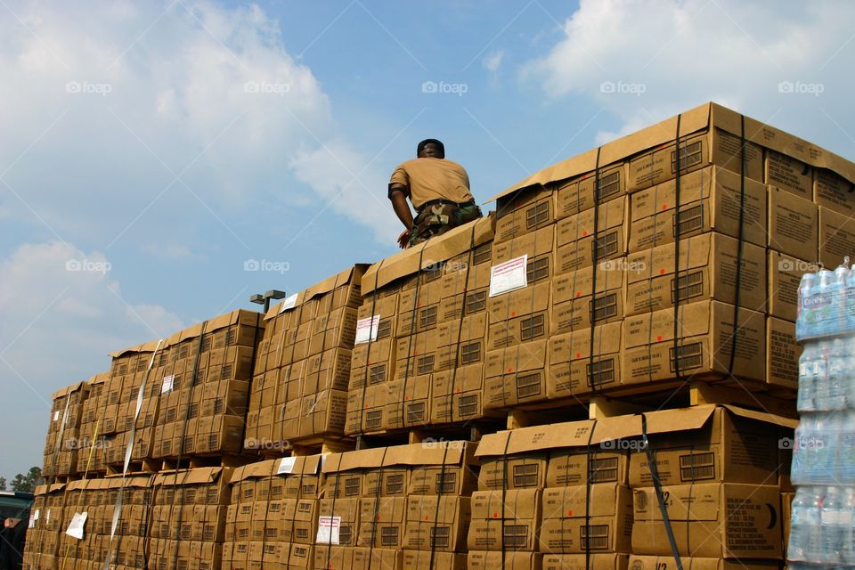 Pallet Director checks box straps before delivery.