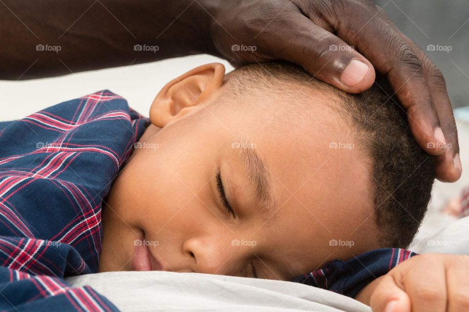 Father helping his son to sleep