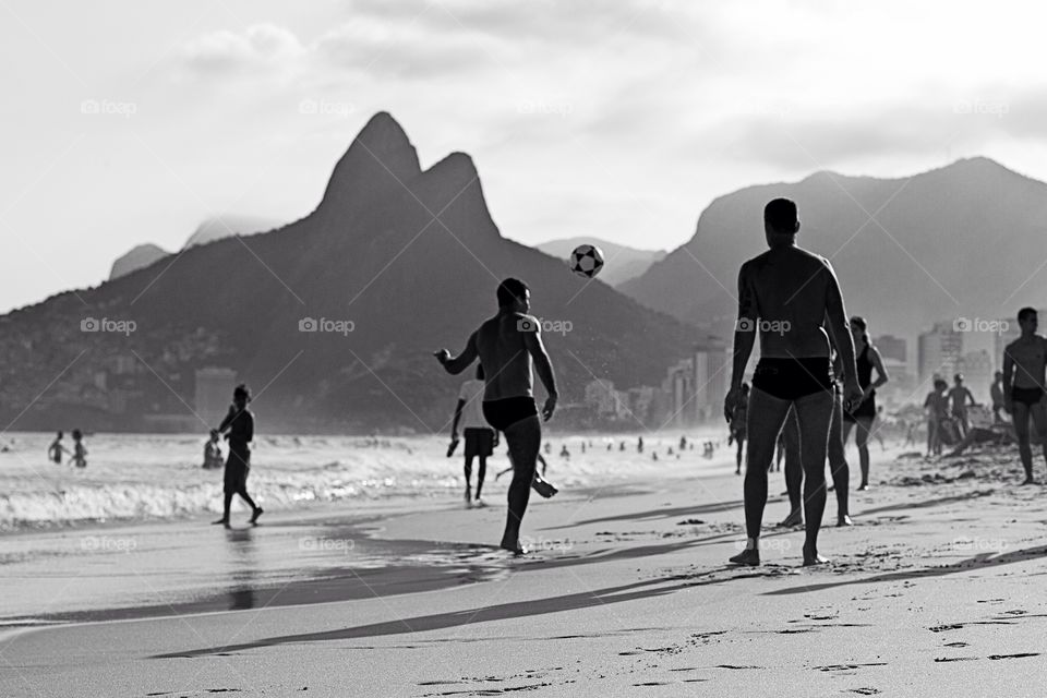 Summer tradition . In Rio de Janeiro is a tradition among locals to play some ball by the ocean