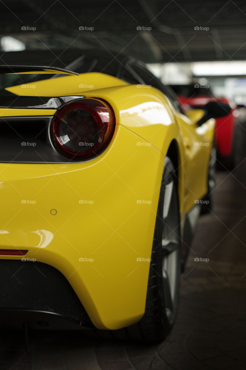 Ferrari 488 spider yellow, back tail light rear view. 3.9 liter V8 twin turbocharged Ferrari 488 sports car produced by the Italian sports car - Ferrari F154CB V8 