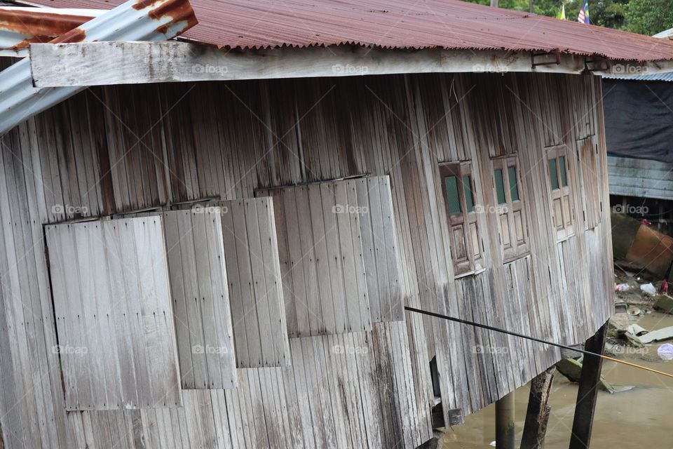 An old tilted house on a riverside. Vintage looks