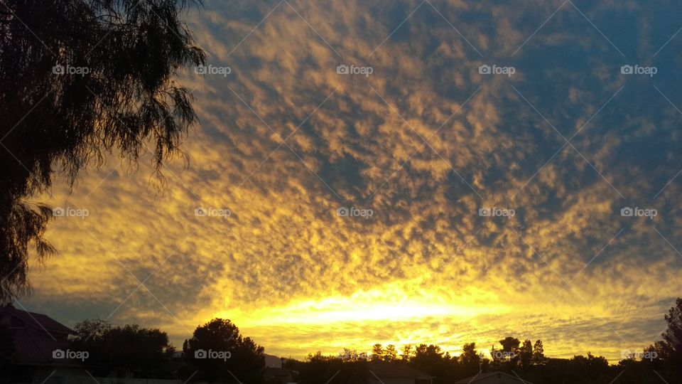 Wild clouds during desert sunset