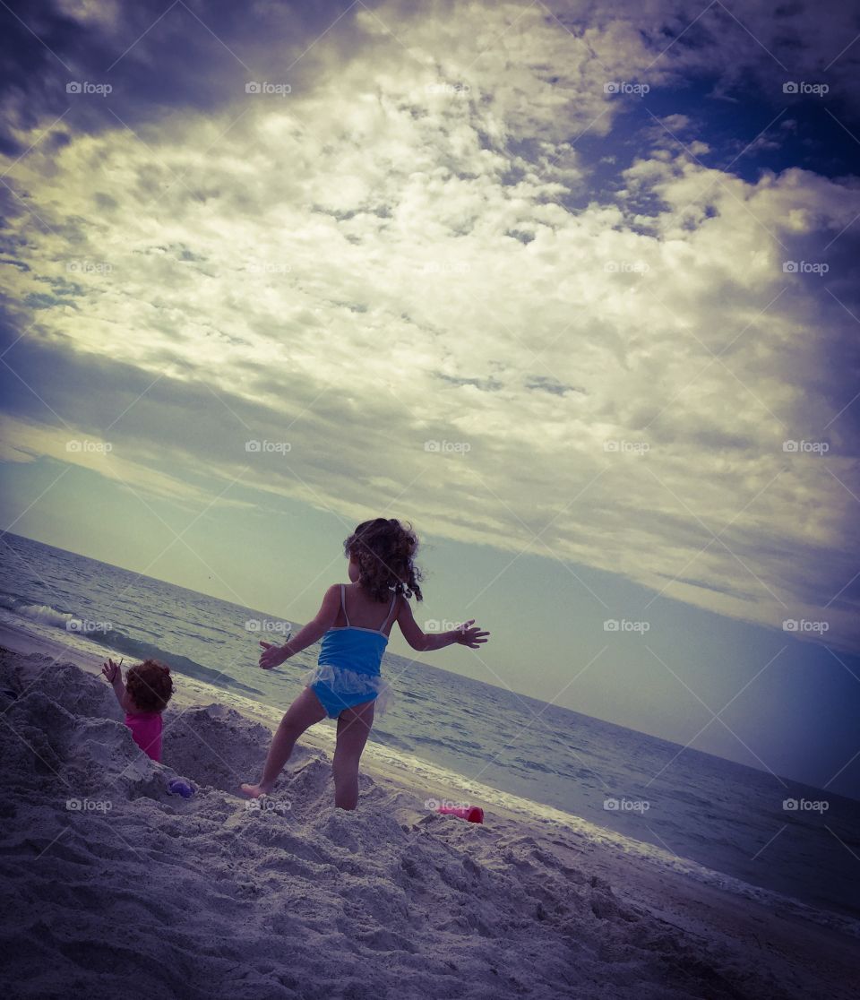 Children playing on sand at beach