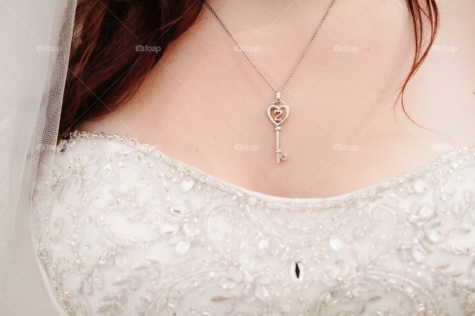Key to my heart. My heart necklace, and corner of my veil. My beaded neckline as well